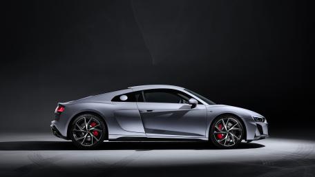 Sleek Performance Sports Car in Spotlight wallpaper