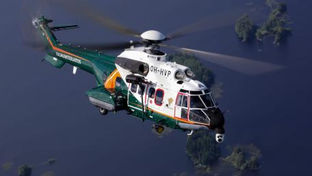 Helicopter in Flight Over Scenic Waterscape wallpaper