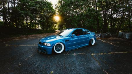 BMW on a road with trees in the background wallpaper
