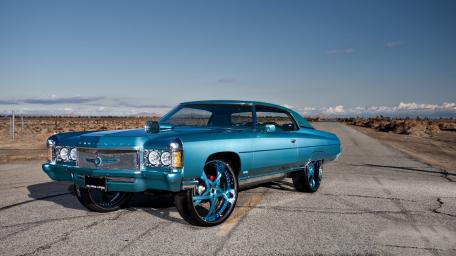 Vintage Blue Muscle Car on Desert Road wallpaper