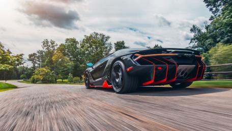 Speeding Lamborghini Centenarió Supercar on a Scenic Road wallpaper