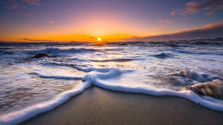 Golden Sunset Over Foamy Seascape in Paekākāriki wallpaper