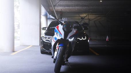 Sleek BMW F90 Motorcycle Emerging from the Shadows wallpaper