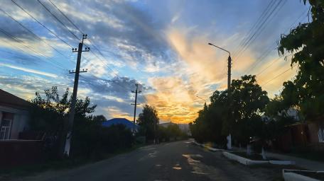 Serene Sunset Over Urban Street Scene wallpaper