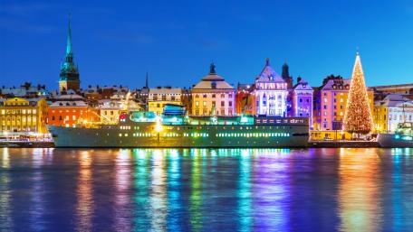 Twinkling Stockholm Cityscape by Nighttime Harbor wallpaper