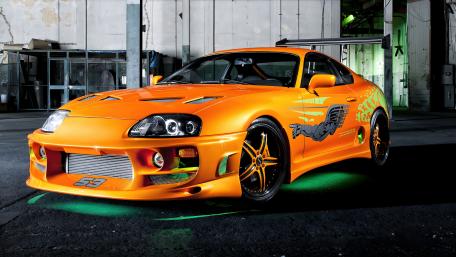 Sleek Orange Toyota Supra Sports Car at Night wallpaper