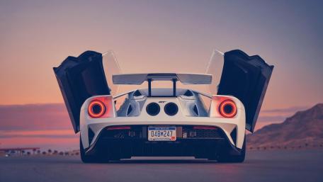 Sleek Ford GT Against Sunset Horizon wallpaper