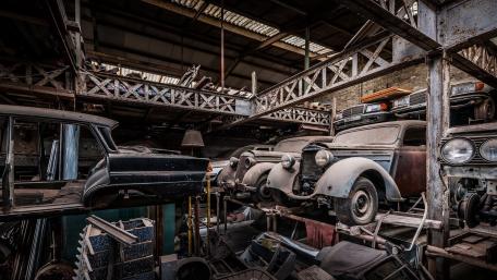 Vintage Car Graveyard in Aged Warehouse wallpaper