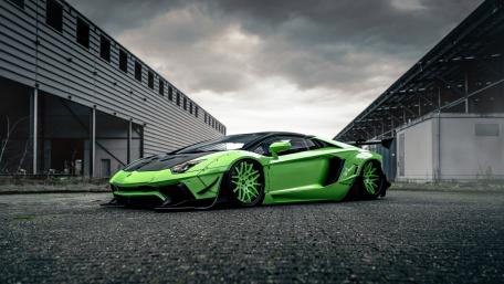 Sleek Green Sports Car Flexes Street Style wallpaper