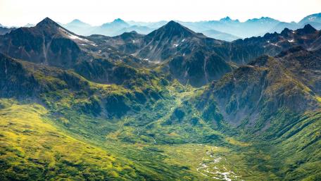 Majestic Kodiak Peaks Bask in Sunlight wallpaper