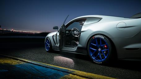 Sleek Ford Mustang Under Night Sky wallpaper