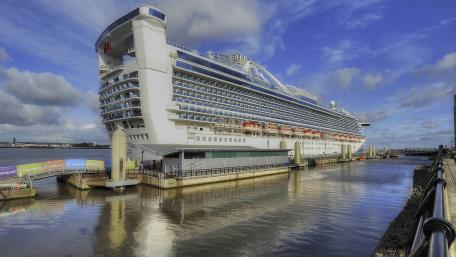 Majestic Ocean Liner Docked Under Blue Skies wallpaper