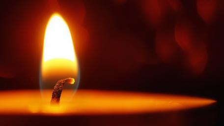 Glowing Warmth of a Single Flame wallpaper
