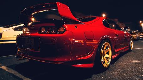 Gleaming Red Supra at Nighttime Gathering wallpaper