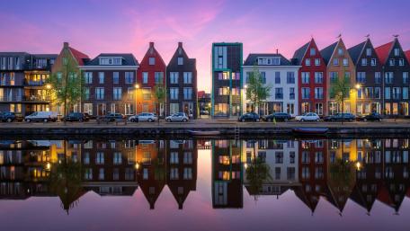 Amsterdam Dawn Reflecting on Canal Waters wallpaper