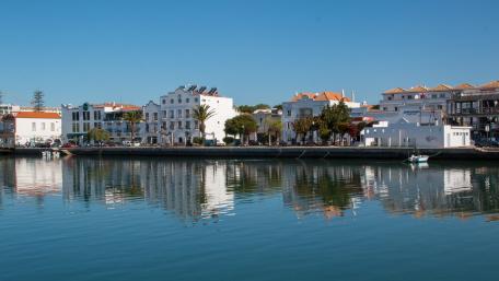Tranquil Waterfront Town Reflection wallpaper
