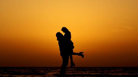 Romantic Silhouette of Couple at Sunset Beach wallpaper