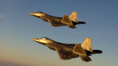 F-22 Raptors Glide at Sunset wallpaper