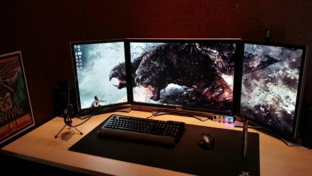 Ultimate Gaming Setup with Triple Monitors wallpaper