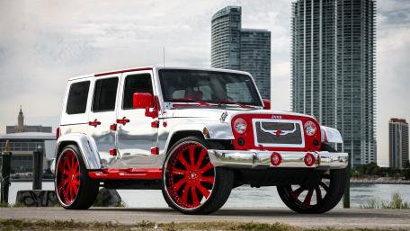 Silver and Red Jeep Wrangler JK against City Backdrop wallpaper