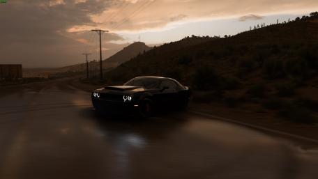 Sleek Black Sports Car on a Rainy Road wallpaper