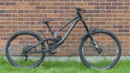 Sleek Mountain Bike Against a Brick Wall wallpaper