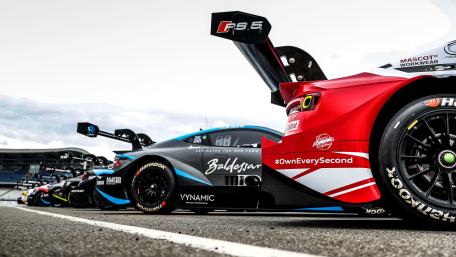 Sleek Race Cars on the Track Showcase wallpaper