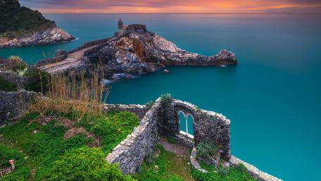 Church Overlooking Tranquil Waters at Sunset wallpaper