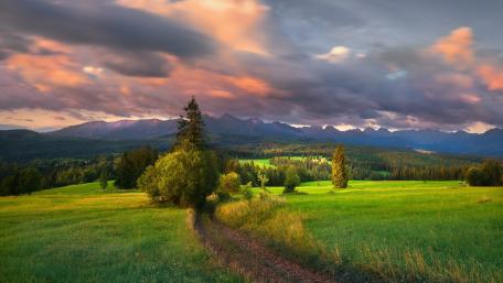 Breathtaking Mountain Landscape Amidst Lush Grasslands wallpaper