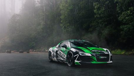 Dynamic Audi Sports Car in Misty Forest Scene wallpaper