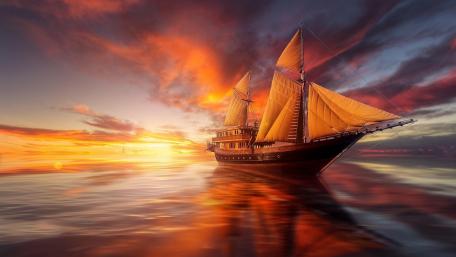 Majestic Ship Under a Vibrant Sunset wallpaper