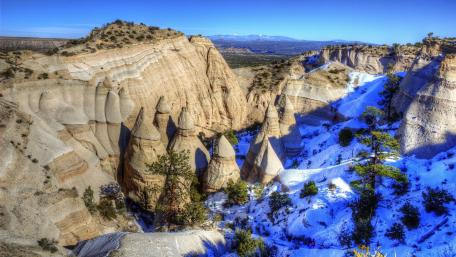 Majestic Rock Formations and Snowy Peaks wallpaper