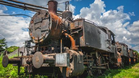 Abandoned Rusty Train Under Blue Sky wallpaper