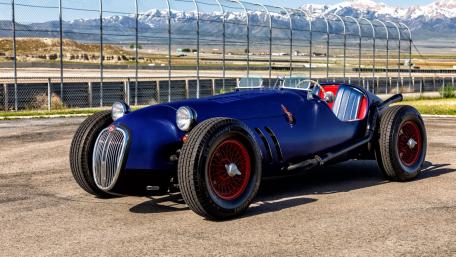 Vintage Blue Roadster in Scenic Background wallpaper