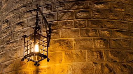 Lantern Glow on Brick Wall wallpaper