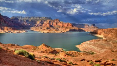 Lake Amidst Rugged Terrains and Majestic Cliffs wallpaper