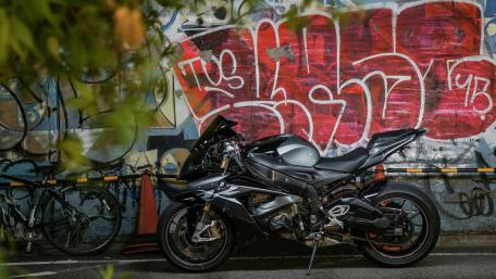 Sleek BMW S1000RR Against Urban Graffiti Background wallpaper