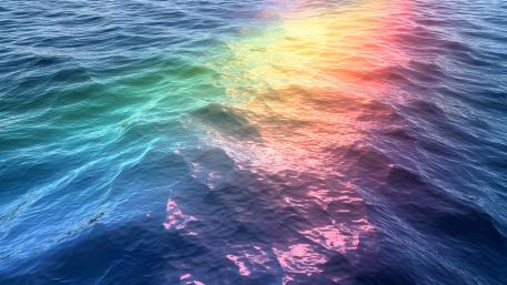 Rainbow Waves Dance on the Ocean Surface wallpaper