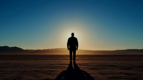 A man stands in front of a sun wallpaper