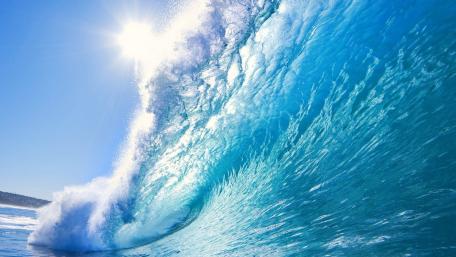 Majestic Blue Ocean Waves Dance Under the Sunlight wallpaper