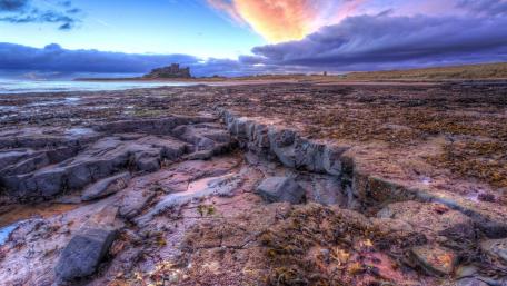 Majestic Bamburgh Castle at Twilight Enhancing Nature's Beauty wallpaper