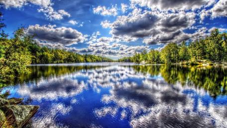 Tranquil River with Fluffy Cloud Reflections wallpaper