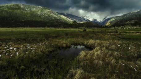 Valley Serenity with Lush Fields and Tranquil Pond wallpaper