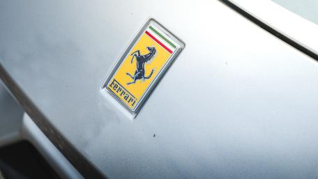 Ferrari Logo on Sleek Silver Surface wallpaper