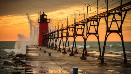 Lighthouse Illuminating the Evening Coastline wallpaper