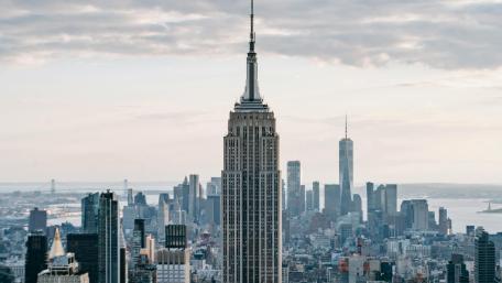 Empire State Majesty Over Manhattan Skyline wallpaper