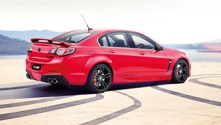 Red HSV Sedan on Scenic Driveway wallpaper