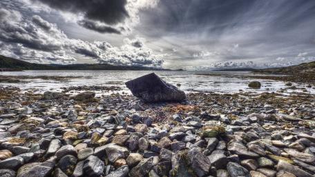 Serene Coastal Landscape with Rocks and Pebbles wallpaper