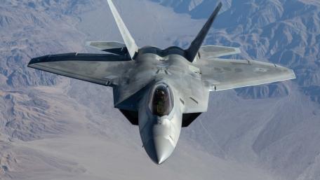 F-22 Raptor Soaring Above the Mountains wallpaper
