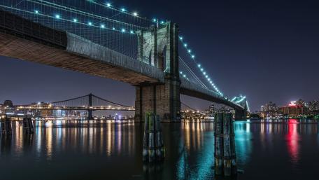 Brooklyn Bridge Illuminated at Night Over East River wallpaper